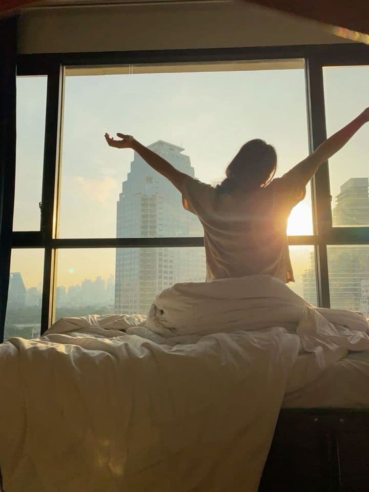 Stretching into first light at the window
