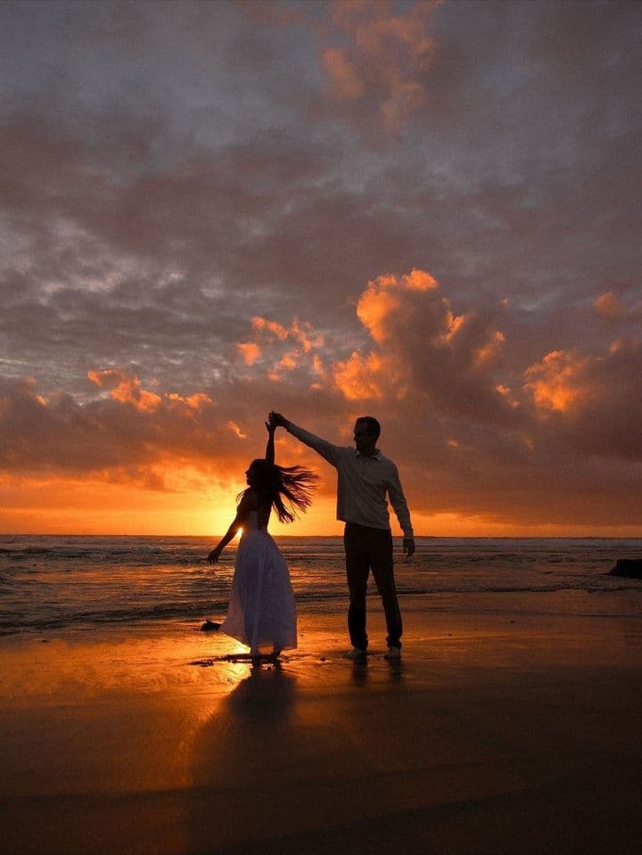 Dancing on the beach at sunset